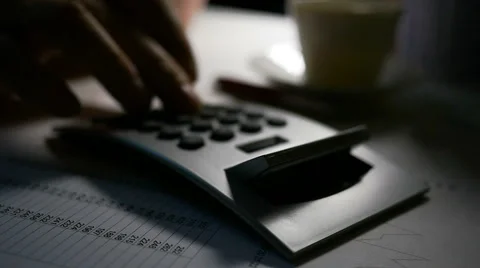 CU wide angle shot of man using calculator, slow motion Stock Footage 61698096