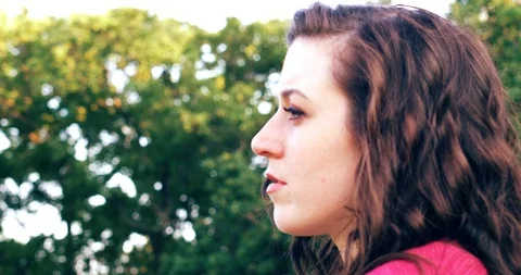 CU of woman outside thinking Stock Footage 90318249