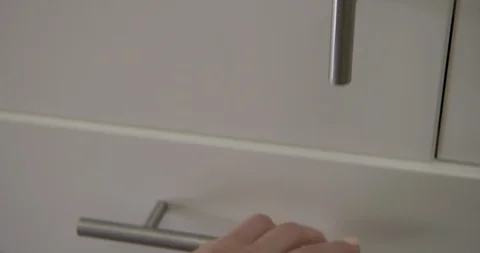 CU woman's hand opens and closes drawer with spoons and forks 4K Stock Footage 91136358