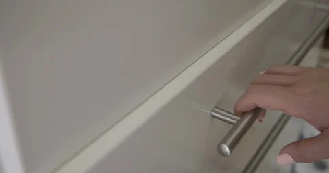 CU woman's hand opens and closes drawer revealing forks 4K Stock Footage 91136694