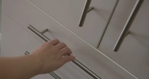 CU woman's hand opens and closes white cutlery drawer 4K Stock Footage 91137344
