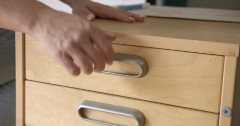 CU Woman's hand opens desk drawer in daylight office 4K Stock Footage 91311181