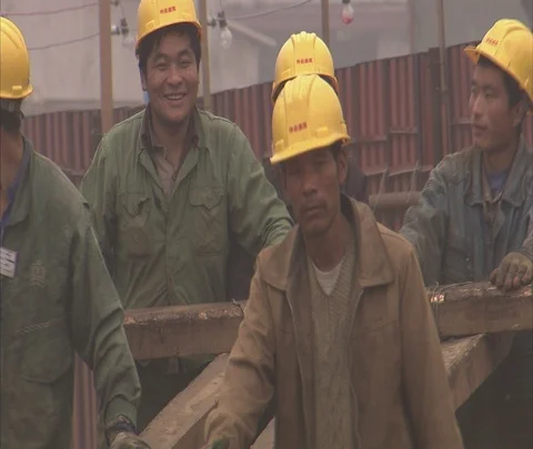 CU workers in hard hats pushing cart on construction site Stock Footage 86744248