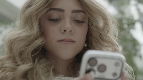 CU of a young woman text on an iPhone indoors, Provo, Utah Stock Footage 338202790