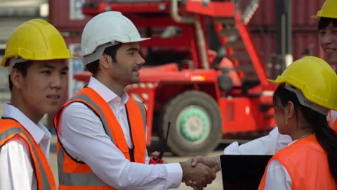 Cuacasian manager shaking hands with group of asian foreman While the forklif Stock Footage 156382999