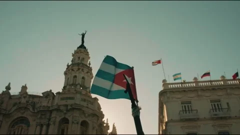 Cuba flag waving in Cuba downtown medium shot Stock Footage 339843405