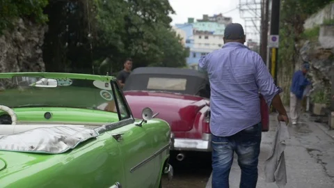 Cuban Cab Driver Waves to Customer Stock Footage 87472657