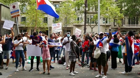 Cuban community protesting on the streets of Paseo de Gracia in front of the Stock Footage 157121500