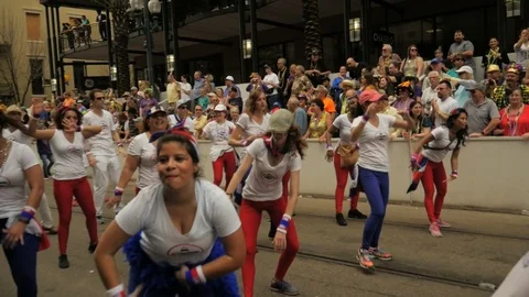Cuban dancers dance troupe group perform for people during Mardi gras parade Stock Footage 85240410