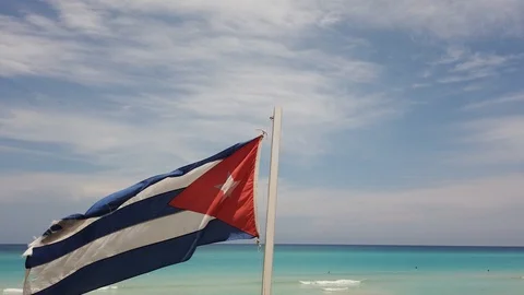 Cuban flag on the beach, flying in the wind on background of ocean. Cuba, Varade Stock Footage 112046858