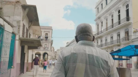Cuban local walks through the streets of Havana Stock Footage 88764437