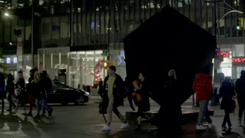 The Cube at Astor Place in NYC at night. Man spinning it. Stock Footage 257481105