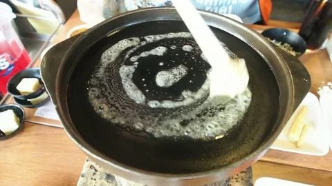 Cube butter melting coating in hot pan barbecue buffet restaurant. 스톡 동영상 83905460