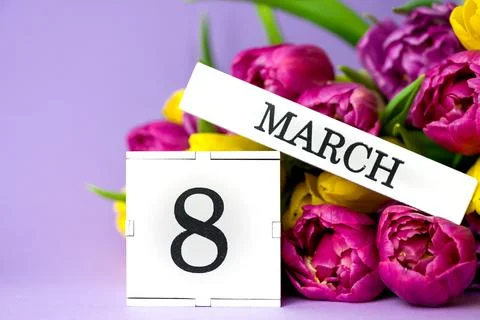 Cube calendar with date MARCH 8 and beautiful bunch of tulips s for Internati Stock Photos