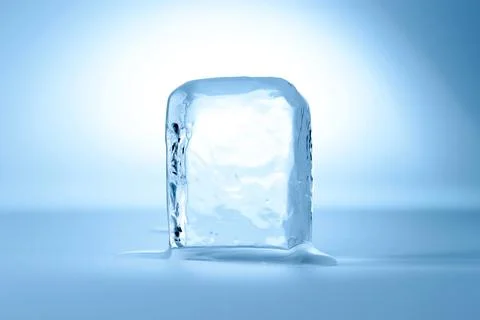Cube of clear ice on light blue background Foto stock