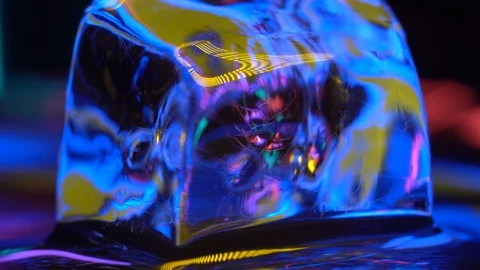 Cube of ice close-up in yellow neon lighting 4K Stock Footage 106831219