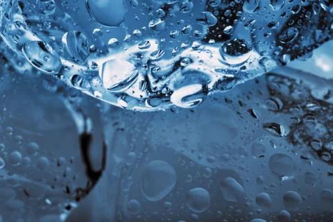 Cube of ice with drops shot close-up Stock Photos