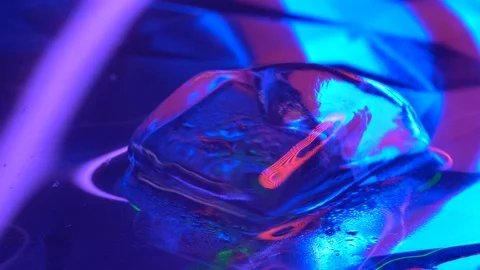 Cube of ice rotating in neon lighting Stock Footage 106829716