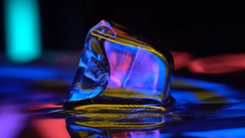 Cube of ice in yellow neon lighting 4K Stock Footage 106830086