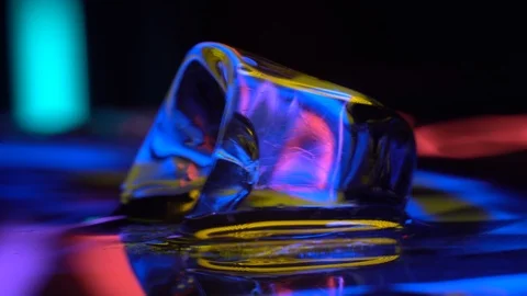 Cube of ice in yellow neon lighting 4K Stock Footage 106830782