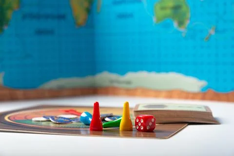 A cube with numbers and chips for a board game. Stock Photos
