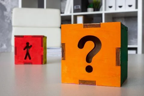 Cube with question mark and a figure of a candidate, symbolizing uncertainty  Stock Photos