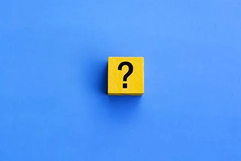 Cube with question mark on blue background. Stock Photos