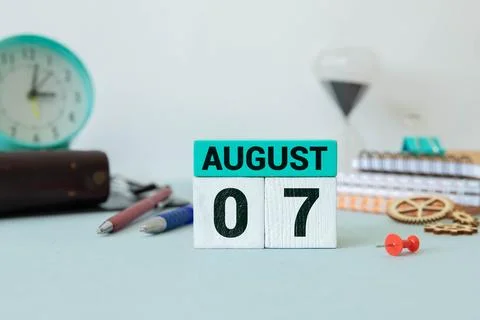 Cube shape calendar for August 07 on wooden surface Stock Photos