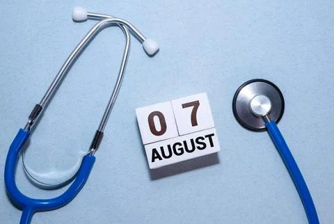 Cube shape calendar for August 07 on wooden surface Stock Photos