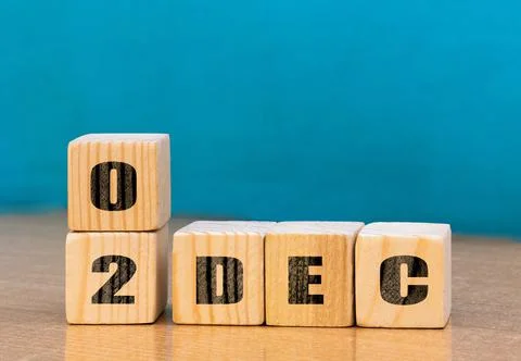 Cube shape calendar for December 02 on wooden surface with empty space Stock Photos