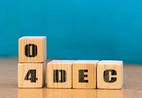 Cube shape calendar for December 04 on wooden surface with empty space Stock Photos