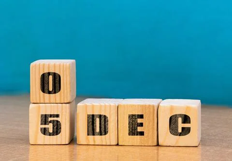 Cube shape calendar for December 05 on wooden surface with empty space Stock Photos