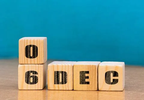 Cube shape calendar for December 06 on wooden surface with empty space Stock Photos