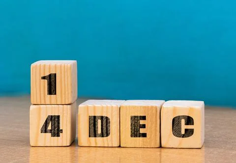 Cube shape calendar for December 14 on wooden surface with empty space Stock Photos