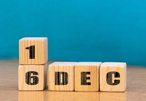 Cube shape calendar for December 16 on wooden surface with empty space Stock Photos