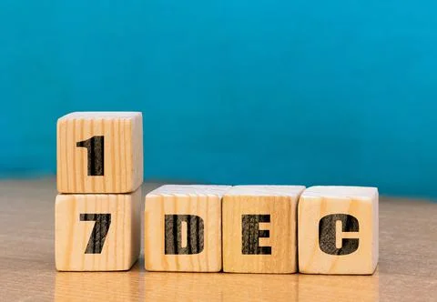 Cube shape calendar for December 17 on wooden surface with empty space Stock Photos