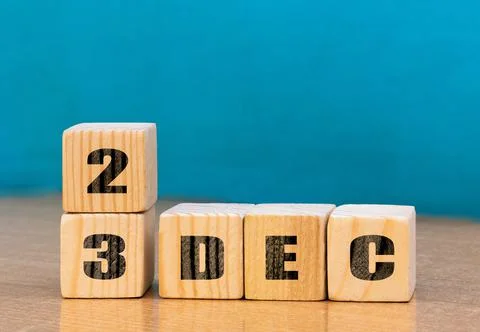 Cube shape calendar for December 23 on wooden surface with empty space Stock Photos