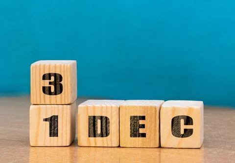 Cube shape calendar for December 31 on wooden surface with empty space Stock Photos