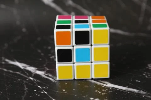 Cube toy on black marble background. Puzzle game Stock Photos