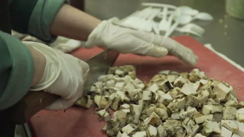 Cubed chicken being sliced Stock Footage 142158010