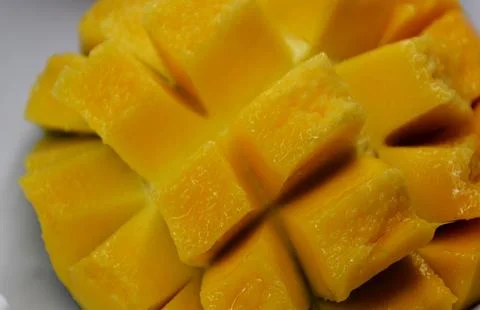 Cubed mango background, close-up, mango background, top view Stock Photos