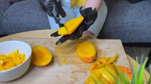 Cubed Mango Held by Gloved Hands Over Cutting Board in Kitchen Prep Scene Stock Footage 311516414