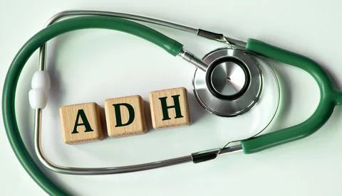 Cubes with the abbreviation ADH on the background of a stethoscope. Stock Photos