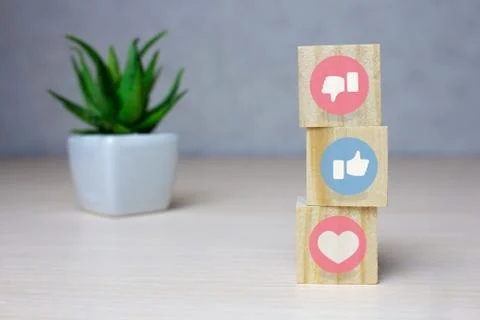 Cubes with the LIKE and a thumb up, thumb down symbol on wooden background. Foto stock