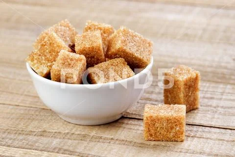 Cubes Of Brown Sugar In Bowl On Wooden Table