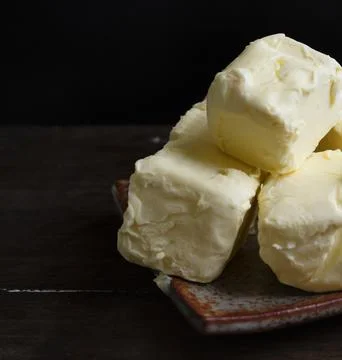 Cubes of butter on a plate Stock Photos