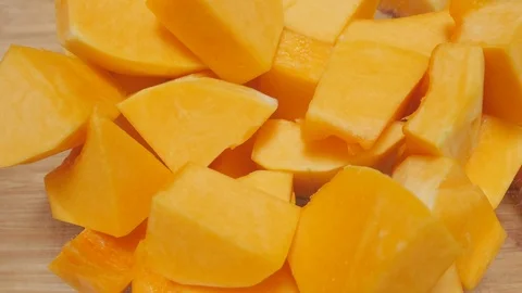 Cubes of Butternut Squash Dropping into a Glass Serving Bowl in 4k Stock Footage 86255836