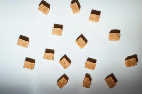 Cubes of cane sugar on a white background with a shadow. Top view. 스톡 사진
