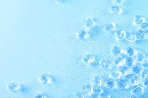 Cubes of clear ice on light blue background, flat lay. Space for text 스톡 사진
