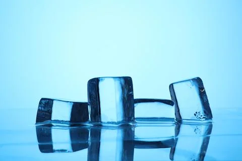 Cubes of clear ice on light blue background, closeup. Space for text 写真素材